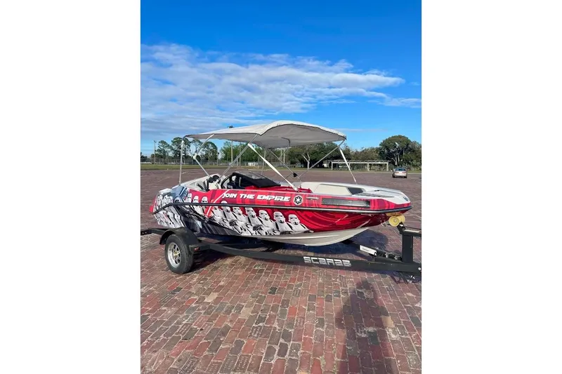 Slide: The Image of 2017 Scarab 165 HO boat with custom Star Wars-themed graphics on a trailer. - 0