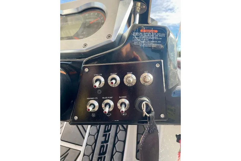 Slide: The Image of Control panel of a 2017 Scarab 165 HO boat with switches and key ignition. - 11