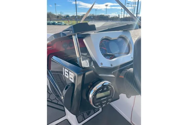 Slide: The Image of Dashboard of a 2017 Scarab 165 HO boat with steering and controls. - 12