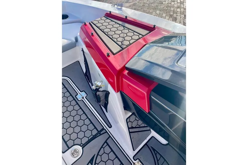 Slide: The Image of 2017 Scarab 165 HO boat interior with red accents and hexagonal flooring design. - 13