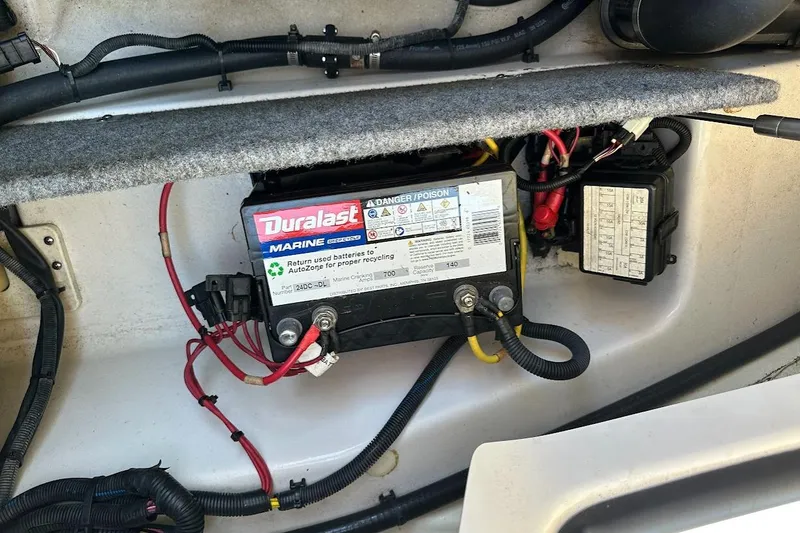 Slide: The Image of Battery compartment of a 2017 Scarab 165 HO with Duralast Marine battery. - 18