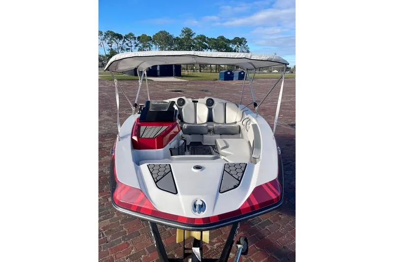 Slide: The Image of 2017 Scarab 165 HO boat with canopy, parked on brick pavement. - 5