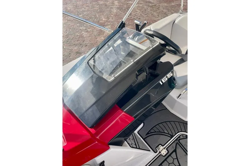 Slide: The Image of 2017 Scarab 165 HO boat dashboard with steering wheel and controls. - 7