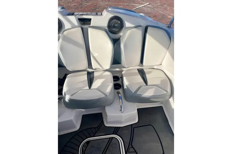 Slide: The Image of 2017 Scarab 165 HO boat interior with white and gray seating, cup holders, and controls. - 8