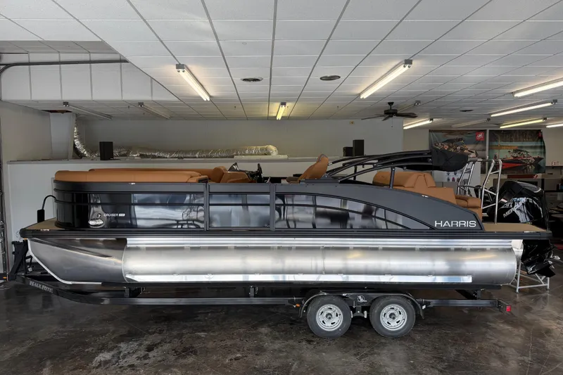 The Image of 2026 Harris Cruiser 230 pontoon boat in showroom on trailer. - 1