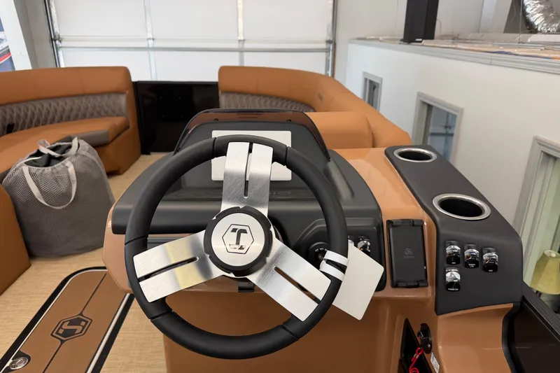 Slide: The Image of 2026 Harris Cruiser 230 boat interior with steering wheel and seating area. - 10