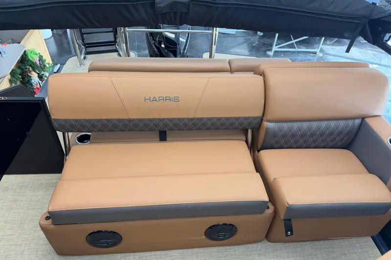 Slide: The Image of Luxurious seating on 2026 Harris Cruiser 230 boat with tan upholstery and cup holders. - 12