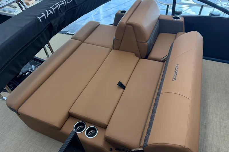 Slide: The Image of 2026 Harris Cruiser 230 boat interior with tan leather seating and cup holders. - 13