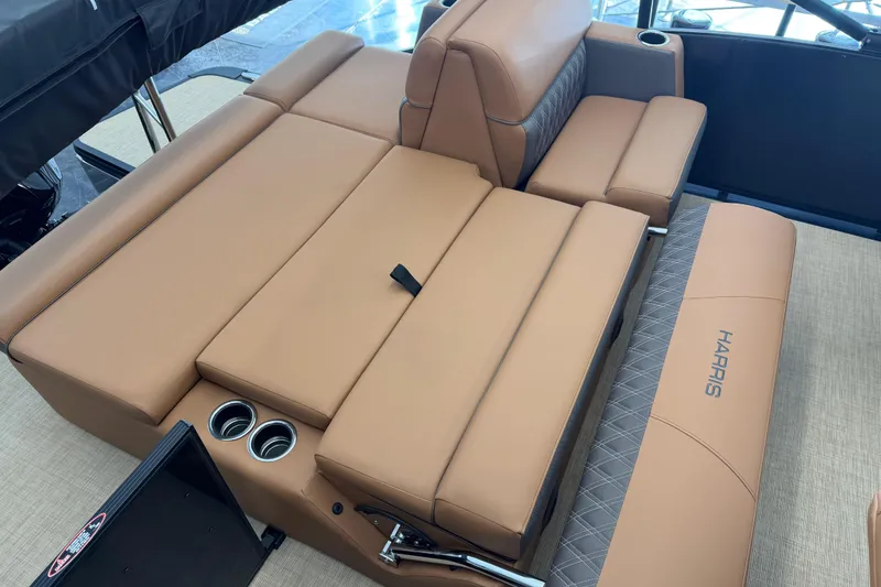 Slide: The Image of Luxurious seating on 2026 Harris Cruiser 230 boat with tan upholstery and cup holders. - 14
