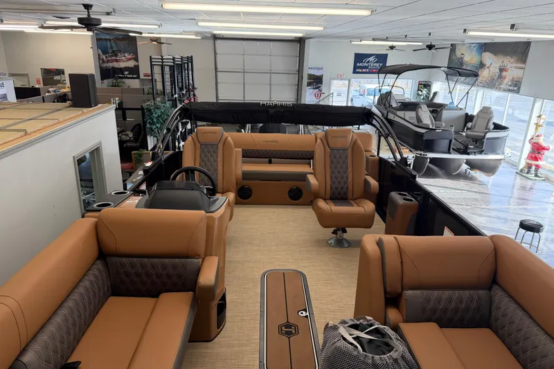 Slide: The Image of 2026 Harris Cruiser 230 pontoon boat interior with luxurious seating in showroom. - 5