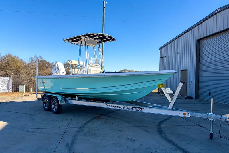 The Image of 2026 Bulls Bay 2200 XS boat on trailer, parked outside a metal building. - 0