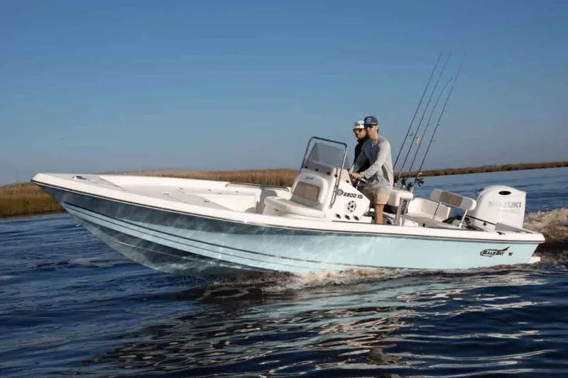 Slide: The Image of Manufacturer Provided Image: 2025 Bulls Bay 2200 XS boat cruising on water with two people onboard. - 12