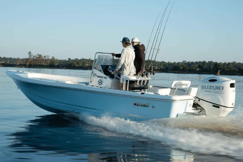Slide: The Image of Manufacturer Provided Image: 2025 Bulls Bay 2200 XS boat cruising on calm water with two passengers. - 13