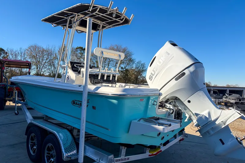 Slide: The Image of 2026 Bulls Bay 2200 XS boat with Suzuki outboard motor on trailer, sunny day. - 9