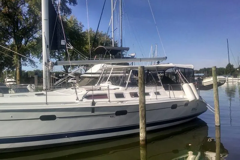 The Image of 2005 Hunter 46LE sailboat docked in a marina on a sunny day. - 0