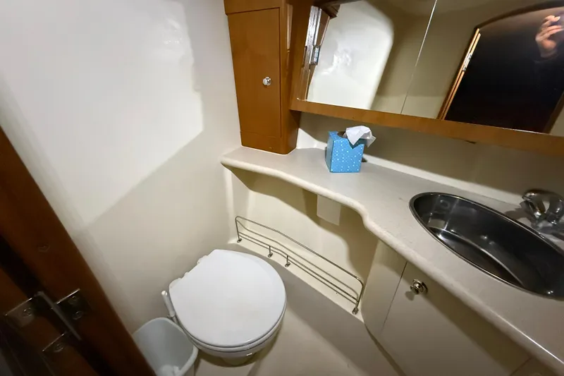Slide: The Image of Compact bathroom in a 2005 Hunter 46LE yacht with sink, toilet, and mirror. - 12