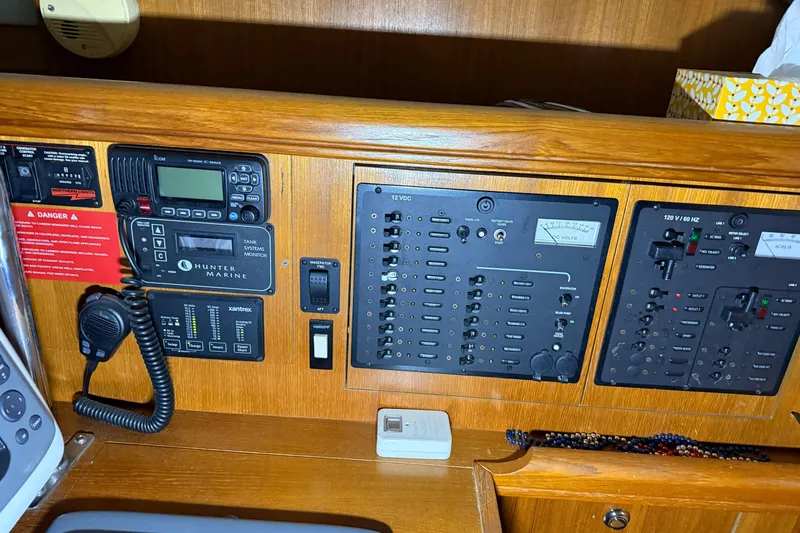 Slide: The Image of Control panel of a 2005 Hunter 46LE yacht with communication and monitoring systems. - 20
