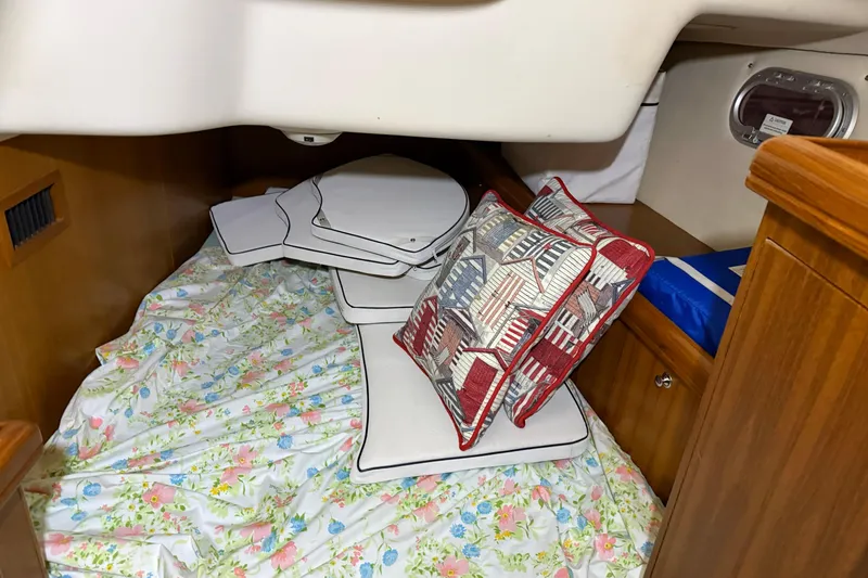 Slide: The Image of Cozy cabin interior of 2005 Hunter 46LE sailboat with floral bedding and decorative pillows. - 23