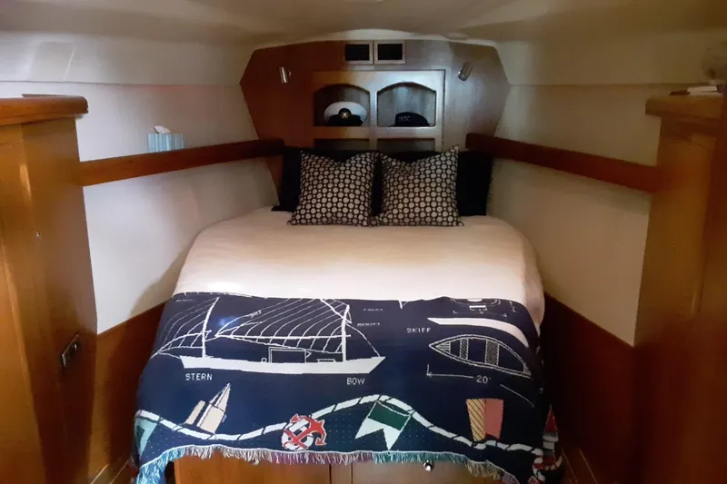 Slide: The Image of Cozy cabin interior of 2005 Hunter 46LE yacht with nautical-themed bedding. - 11