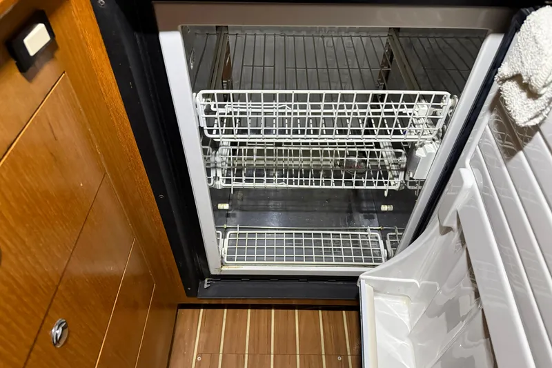 Slide: The Image of Open refrigerator with wire shelves inside a 2005 Hunter 46LE boat interior. - 15