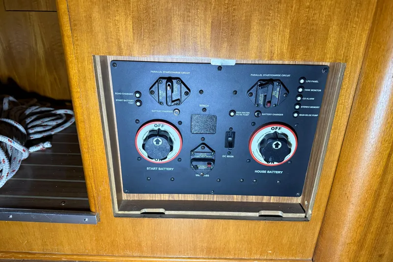 Slide: The Image of Control panel of a 2005 Hunter 46LE yacht, featuring battery switches and indicators. - 21