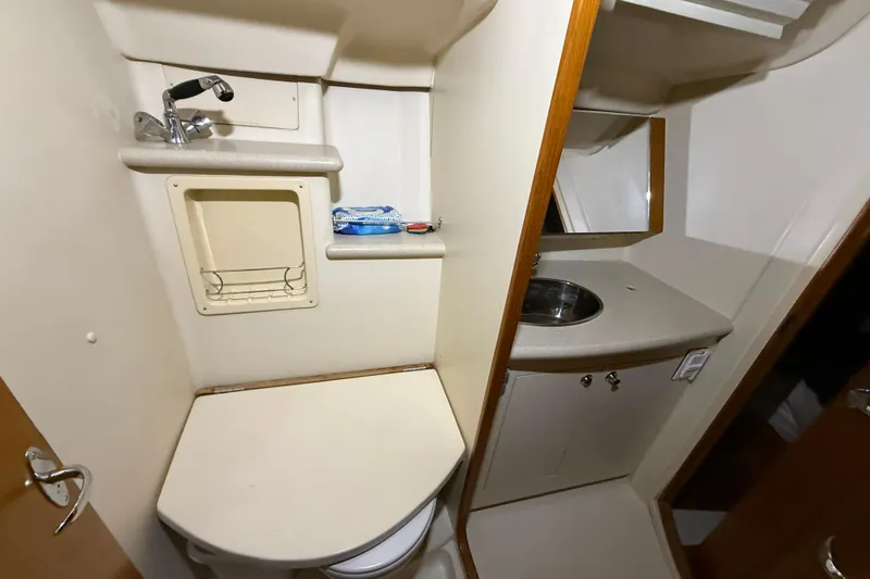 Slide: The Image of Compact bathroom in 2005 Hunter 46LE yacht with sink, mirror, and toilet. - 22