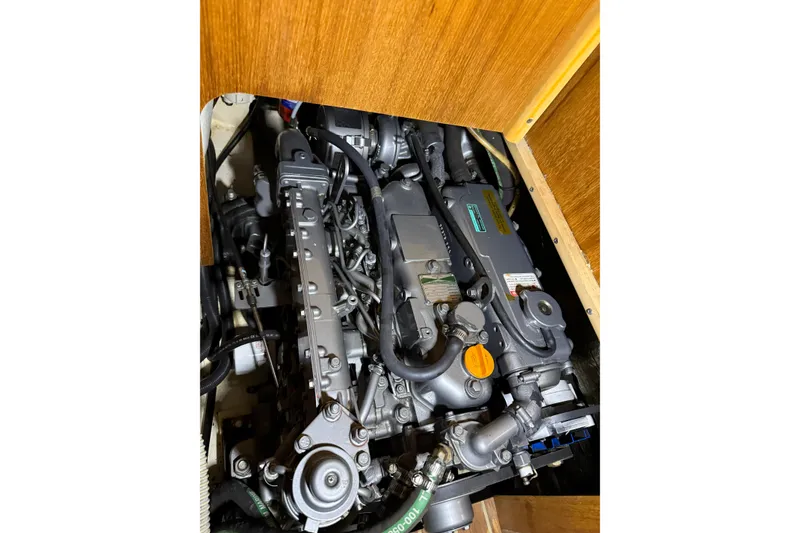 Slide: The Image of Engine compartment of a 2005 Hunter 46LE sailboat, showcasing mechanical components. - 24