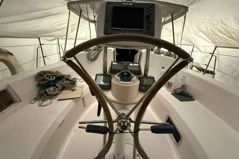 Slide: The Image of Interior view of 2005 Hunter 46LE sailboat cockpit with steering wheel and navigation equipment. - 8