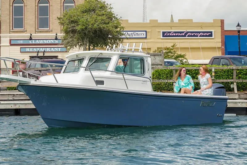 Slide: The Image of Manufacturer Provided Image: 2019 Parker 2320 Sport Cabin boat docked near waterfront shops. - 12