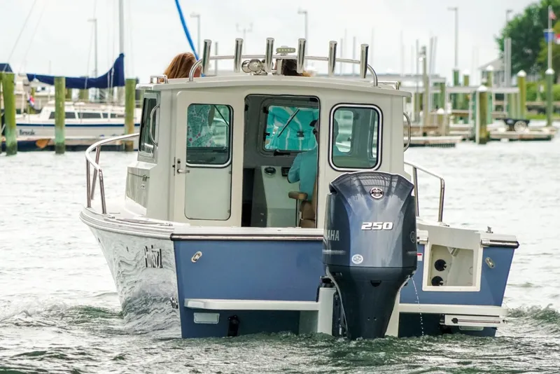 Slide: The Image of Manufacturer Provided Image: 2019 Parker 2320 Sport Cabin boat with Yamaha 250 outboard motor in marina. - 13