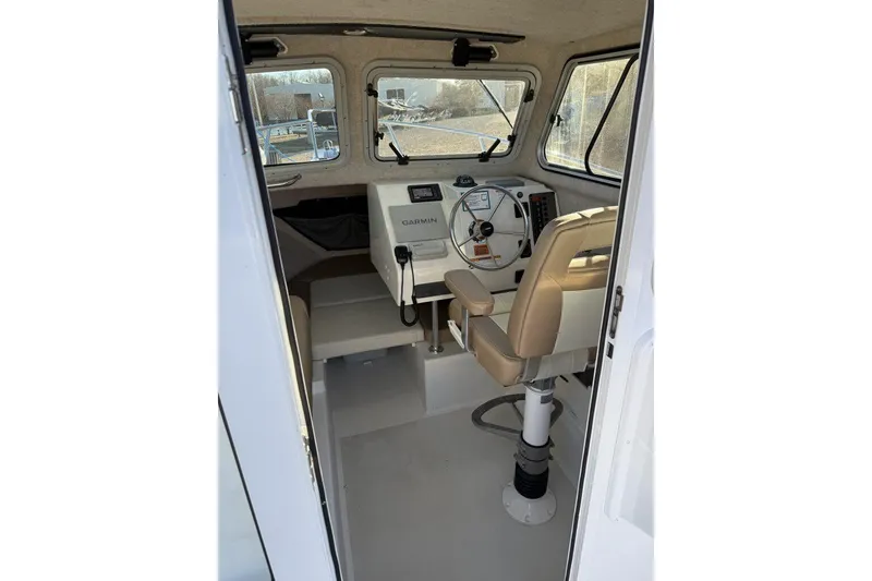 Slide: The Image of Interior of 2019 Parker 2320 Sport Cabin with beige seating and window view. - 5