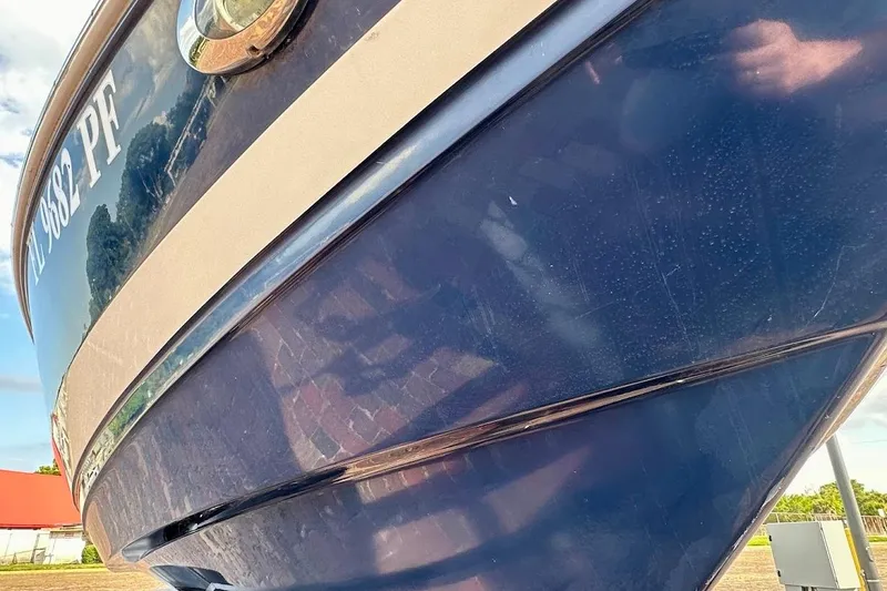 Slide: The Image of 2012 Regal 2100 Bowrider boat, close-up of blue hull and registration number. - 16