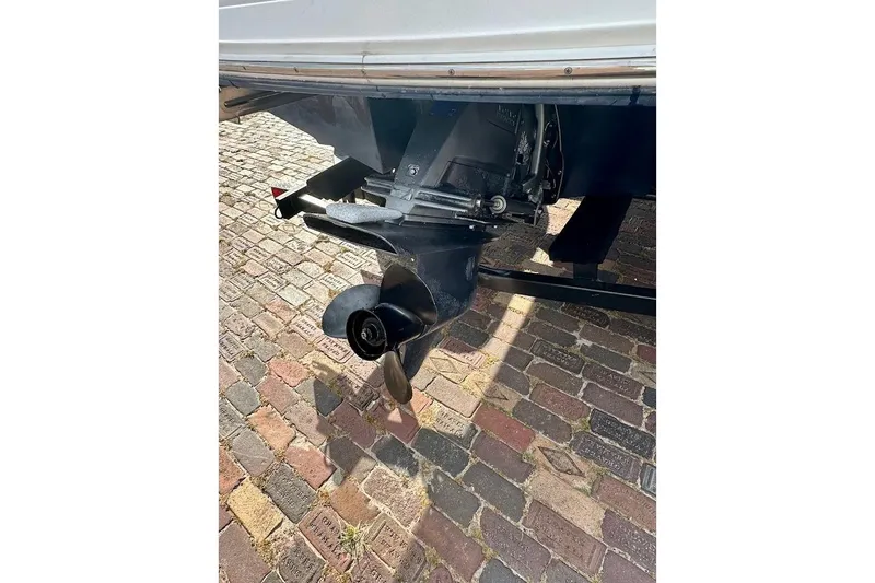 Slide: The Image of 2012 Regal 2100 Bowrider boat propeller on cobblestone pavement. - 19