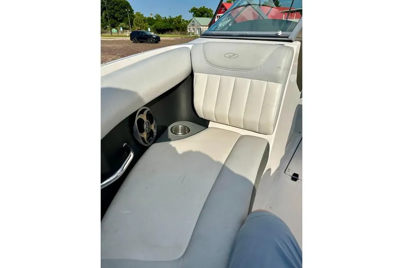 Slide: The Image of 2012 Regal 2100 Bowrider interior with cushioned seating and cup holder. - 32