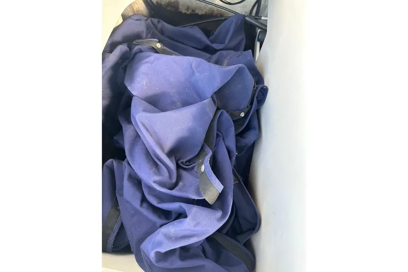 Slide: The Image of Blue fabric stored in a compartment of a 2012 Regal 2100 Bowrider boat. - 37