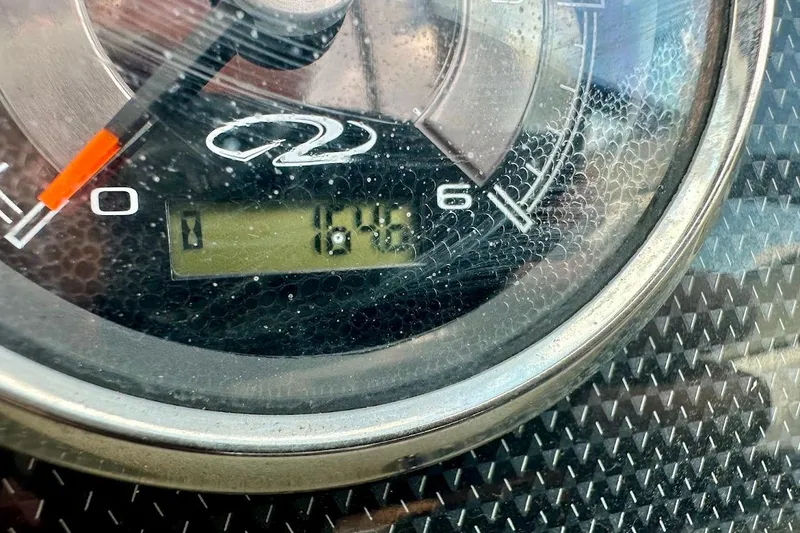 Slide: The Image of Close-up of a 2012 Regal 2100 Bowrider speedometer displaying 164.6 hours. - 38