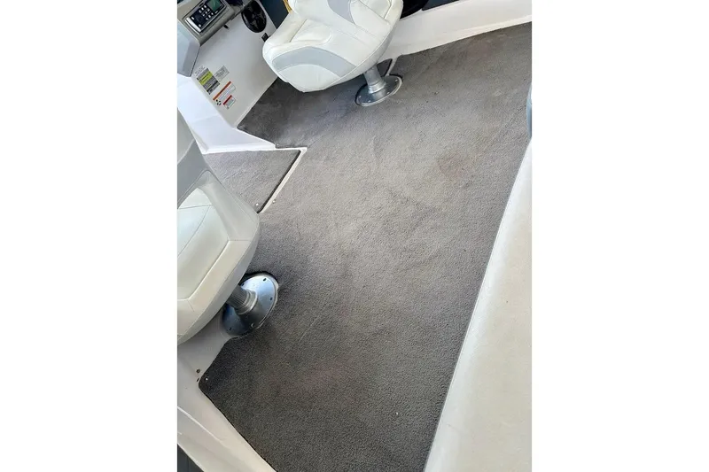 Slide: The Image of Interior of 2012 Regal 2100 Bowrider boat with gray carpet and white seating. - 41