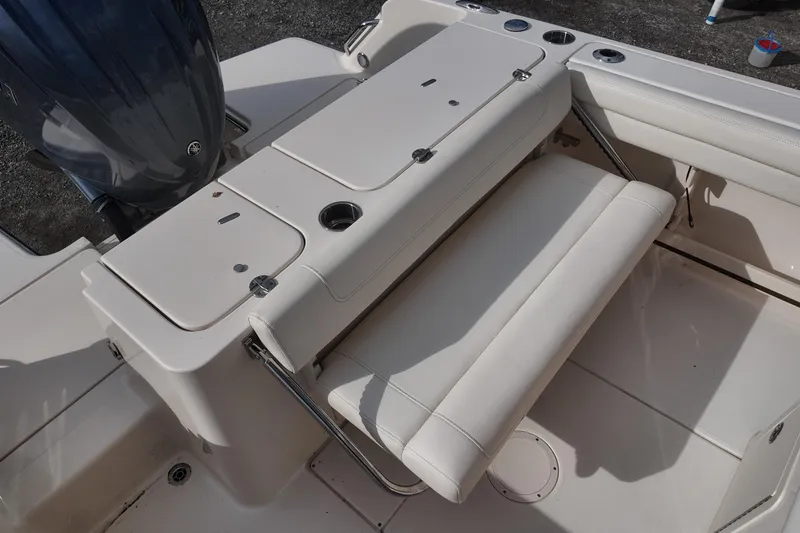 Slide: The Image of 2023 Grady White Fisherman 236 boat seating and storage area with engine view. - 14