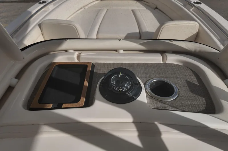 Slide: The Image of 2023 Grady White Fisherman 236 boat dashboard with compass and cup holder. - 18