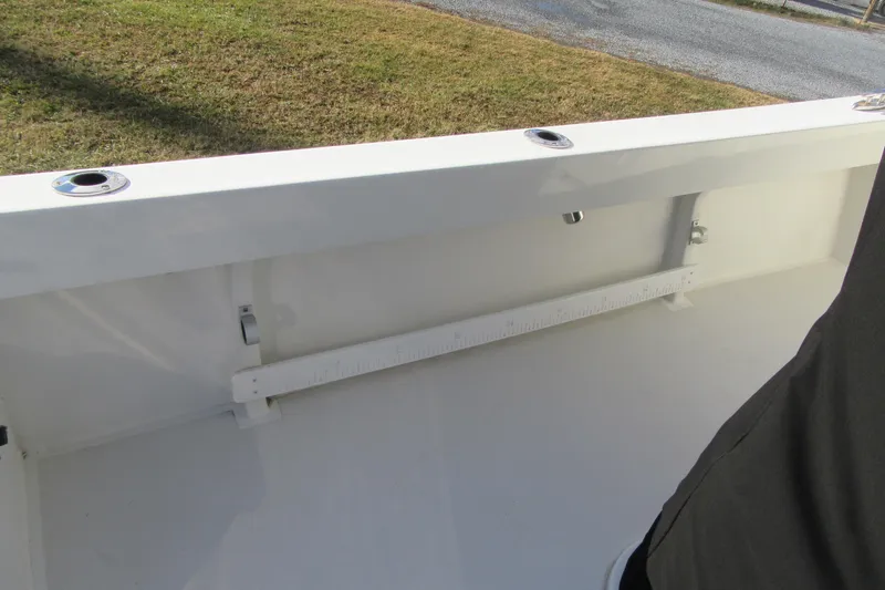 Slide: The Image of 2022 Parker 2300 Special Edition boat interior with rod holders and measuring ruler. - 15