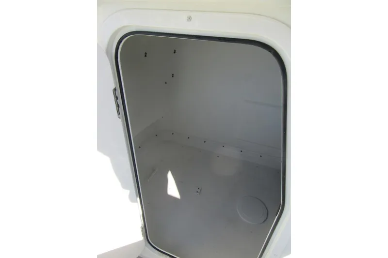 Slide: The Image of Storage compartment of 2022 Parker 2300 Special Edition boat, open and empty. - 22