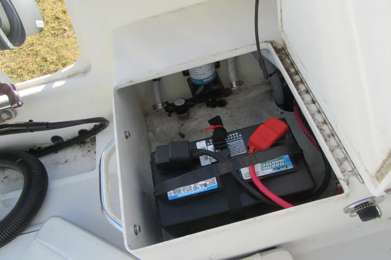 Slide: The Image of Battery compartment of 2022 Parker 2300 Special Edition boat, featuring marine battery and wiring. - 24