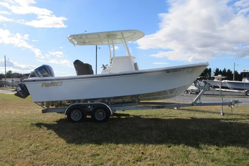 Slide: The Image of 2022 Parker 2300 Special Edition boat on trailer, parked on grass under a partly cloudy sky. - 3