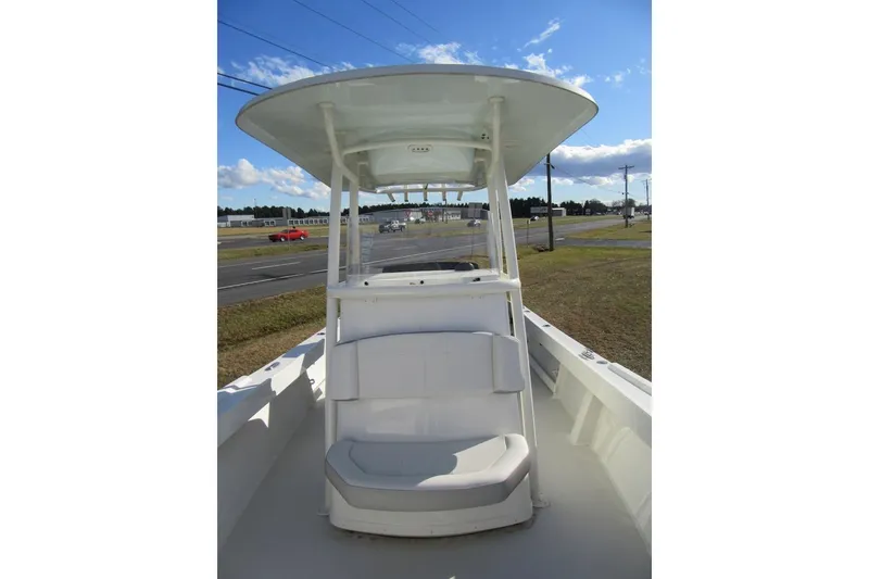 Slide: The Image of 2022 Parker 2300 Special Edition boat with T-top and seating, parked near a road. - 7