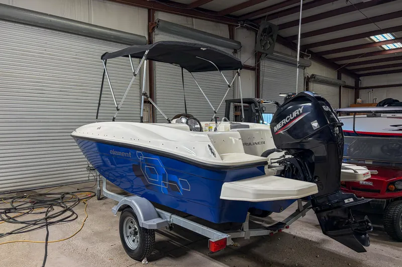 The Image of 2020 Bayliner Element E16 boat with Mercury engine in a garage. - 1