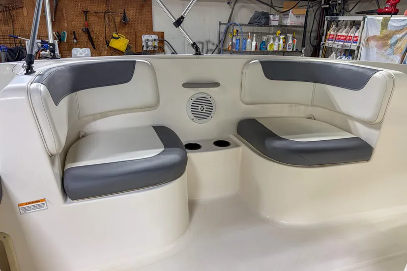 Slide: The Image of 2020 Bayliner Element E16 boat interior with gray and white seating. - 10