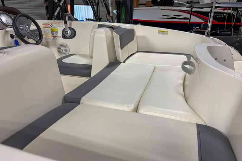 Slide: The Image of 2020 Bayliner Element E16 boat interior with white and gray seating. - 3