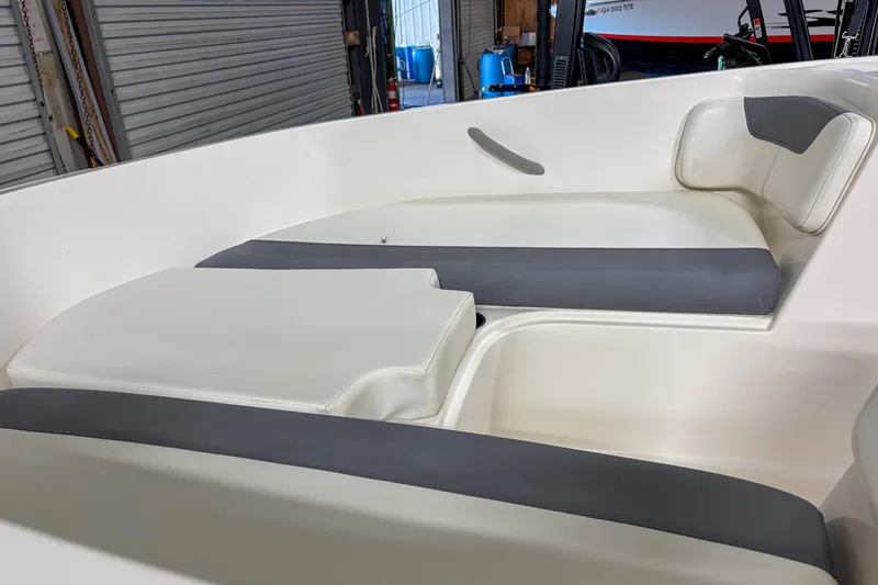 Slide: The Image of 2020 Bayliner Element E16 boat interior with white and gray seating. - 5