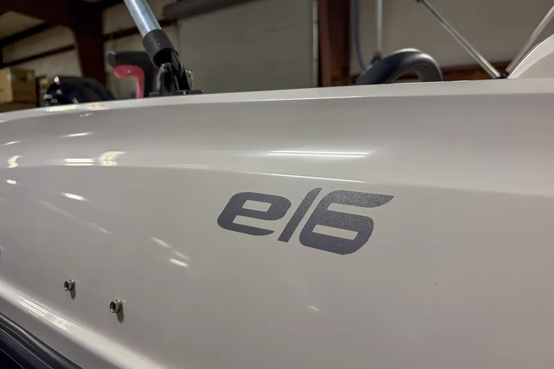 Slide: The Image of 2020 Bayliner Element E16 boat side view with logo in a garage setting. - 8