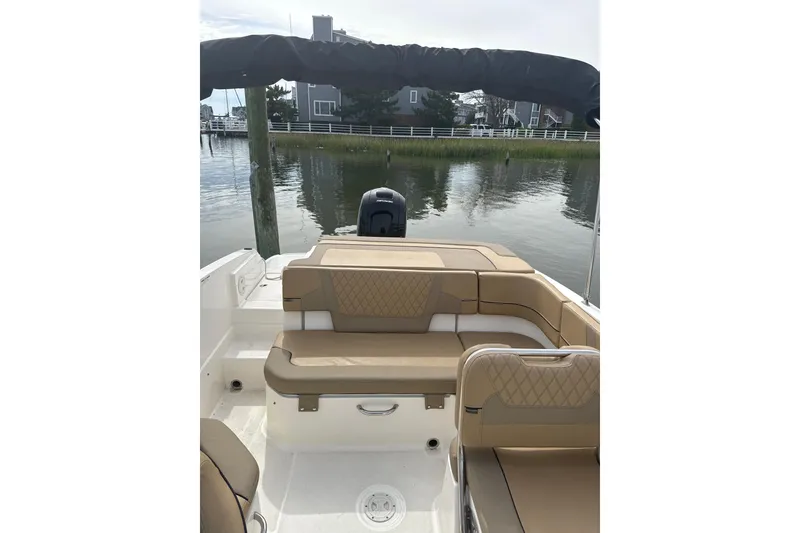 Slide: The Image of 2025 Bayliner VR6 Bowrider OB with tan seating, docked by calm waters. - 4
